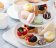 Spring or summer dessert table, three tiered tray with desserts etagere met macrons en zoetigheden